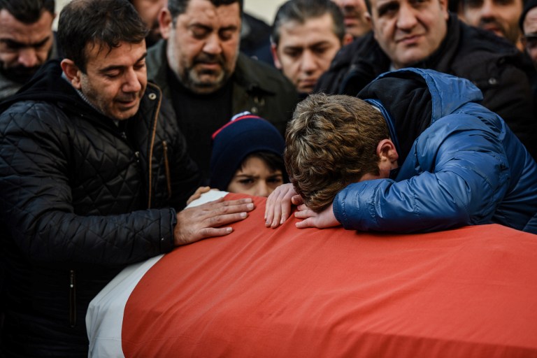 Relatives of Ayhan Arik, one of the victims of the Reina night club attack mourn during his funeral ceremony on January 1, 2017 in Istanbul. Thirty-nine people, including many foreigners, were killed early on January 1, 2016 when a gunman went on a rampage at an exclusive nightclub in Istanbul where revellers were celebrating the New Year. / AFP PHOTO / OZAN KOSE