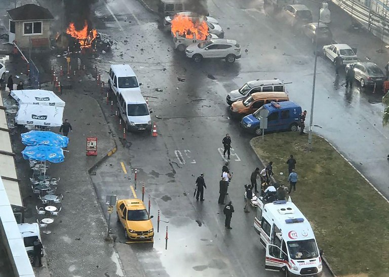 Cars burn in the street at the site of an explosion in front of the courthouse in Izmir on January 5, 2017.   A car bomb exploded outside a courthouse in the western Turkish city of Izmir, wounding at least 10 people and sparking clashes in which at least two "terrorists" were killed, officials and reports said.Several ambulances were rushed to the scene after the blast outside the prosecutors and judges' entrance to the court in the usually peaceful city on the Aegean Sea, the channel said.  / AFP PHOTO / DOGAN NEWS AGENCY / DHA