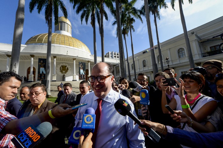 The opposition's parliamentary group leader Julio Borges (C), recently appointed president of the Venezuelan National Assembly, talks to the press as he arrives at the National Assembly for the swearing-in ceremony of the 2017 legislative authorities in Caracas on January 5, 2017. Crisis-hit Venezuela's divided opposition relaunches fraught efforts on Thursday to oust Socialist President Nicolas Maduro. Outgoing assembly speaker Henry Ramos Allup said it was "useless to negotiate with a dictatorship." Ramos is due to be replaced as speaker by the opposition's parliamentary group leader Julio Borges. Borges has vowed to work for "unity" within the opposition. / AFP PHOTO / FEDERICO PARRA