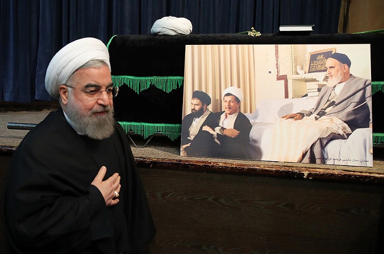 A handout photo provided by the office of the Iranian President Hasan Rouhani shows him praying next to the coffin of former Iranian president Akbar Hashemi Rafsanjani during a mourning ceremony at the Jamaran mosque in Tehran on January 9, 2017. Rafsanjani died in hospital on January 8 after suffering a heart attack. Rafsanjani, who was 82, was a pivotal figure in the foundation of the Islamic republic in 1979, and served as president from 1989 to 1997. / AFP PHOTO / IRANIAN PRESIDENCY / HO / RESTRICTED TO EDITORIAL USE - MANDATORY CREDIT "AFP PHOTO / IRANIAN PRESIDENCY" - NO MARKETING - NO ADVERTISING CAMPAIGNS - DISTRIBUTED AS A SERVICE TO CLIENTS