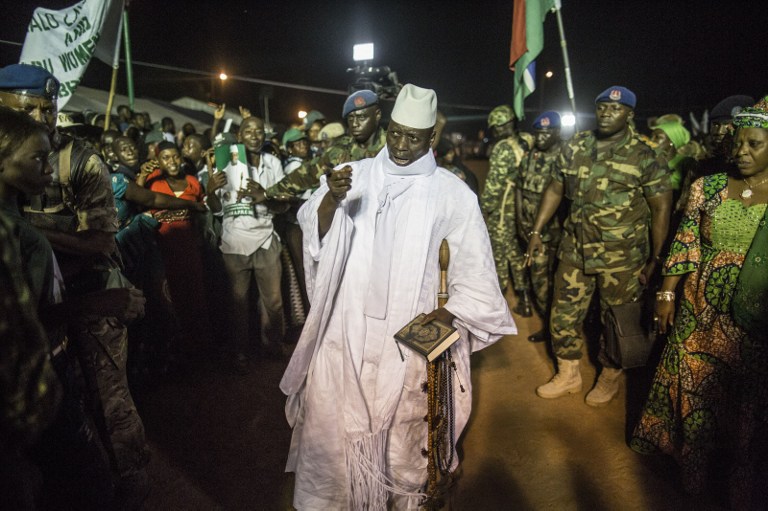 (FILES) This file photo taken on November 24, 2016 in Brikama shows Gambia's incumbent President Yahya Jammeh (C) greeted by supporters as he arrives at a campaign rally ahead of the December 1 presidential election. Gambian president declares state of emergency, AFP reported on January 17, 2017 as President Yahya Jammeh is refusing to quit days before the planned inauguration of his rival Adama Barrow. / AFP PHOTO / MARCO LONGARI