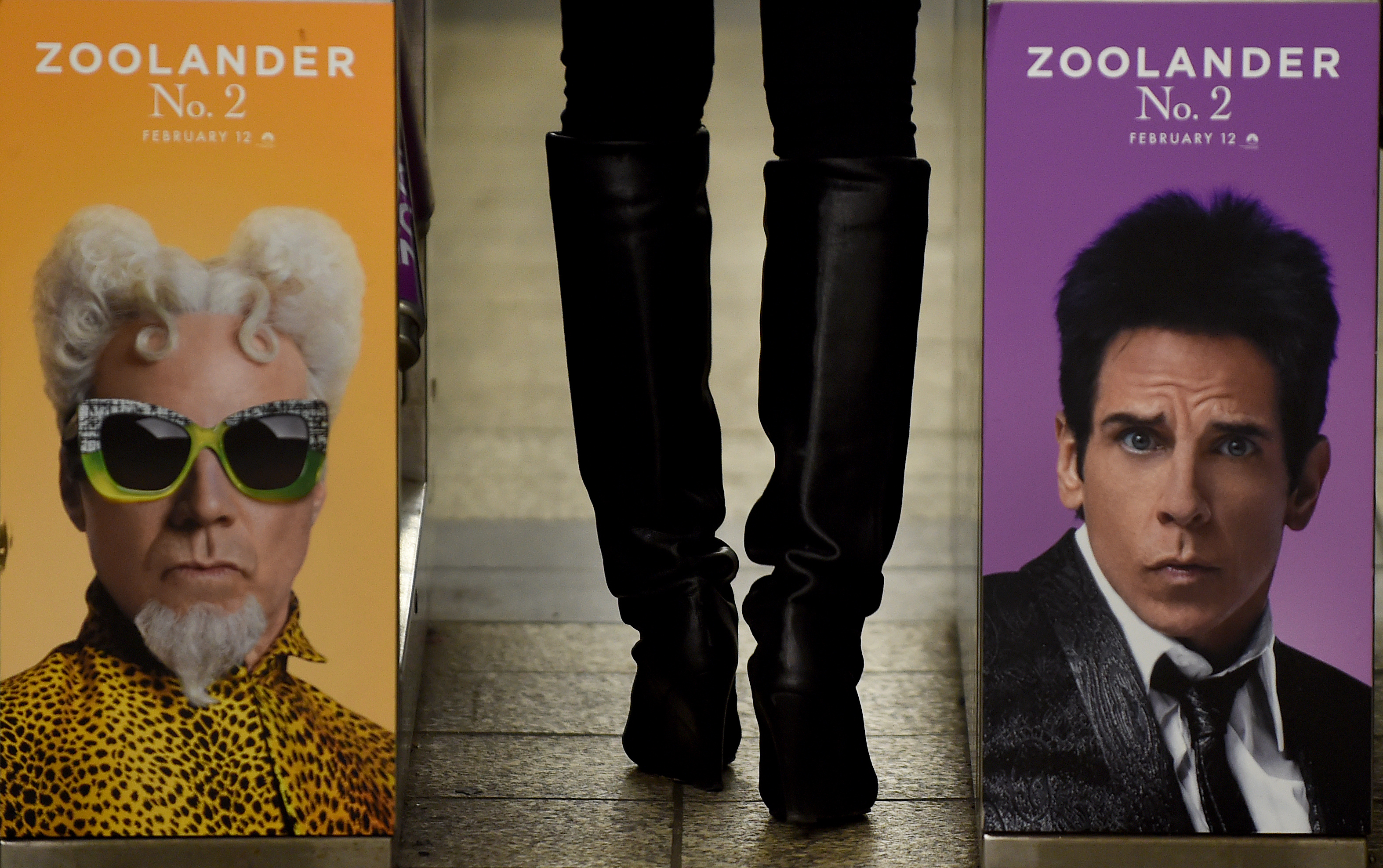 (FILES) This file photo taken on February 25, 2016 shows a woman passing through a turnstile in the New York City Subway with a advertisment for "Zoolander No. 2" featuring Ben Stiller (R) and Will Ferrell. "Zoolander," and "Batman v Superman" topped nominations announced  January 23, 2017 for the Razzies, Hollywood's anti-awards celebrating the worst films of 2016. Leading the list is "Zoolander No. 2." -- "the 15-years-too-late sequel" -- with nine nominations including for worst picture, worst actor (Ben Stiller) and worst supporting actress (Kristen Wiig).  / AFP PHOTO / Timothy A. CLARY