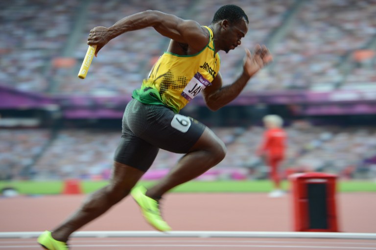 (FILES) This file photo taken on August 10, 2012 shows Jamaica's Nesta Carter competing in the men's 4 x 100m relay heats at the athletics event of the London 2012 Olympic Games on August 10, 2012 in London.  The International Olympic Committee said on January 25, 2017 it had stripped Jamaica of their gold medal earned in the 4x100m relay at the 2008 Beijing Games after Nesta Carter was caught doping.The decision which follows the retesting of hundreds of samples from the Beijing event, means teammate Usain Bolt loses one of the three gold medals he won at that Olympics. Carter was found to have tested positive for banned substance Methylhexanamine. / AFP PHOTO / Eric Feferberg