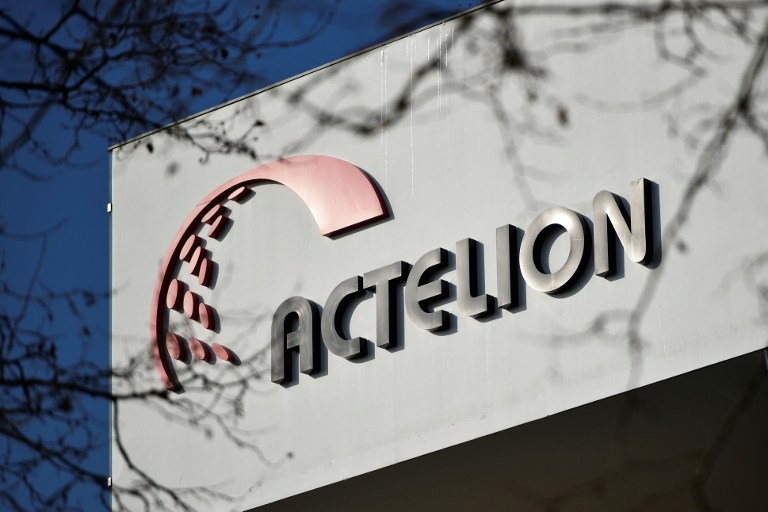 A logo of  Swiss medical firm Actelion is pictured on January 26, 2017 at the company's headquarters in Allschwil near Basel. US pharmaceuticals giant Johnson & Johnson announced it was buying Europe's biggest bio-pharmaceutical firm, Switzerland's Actelion, for $30 billion (27.9 billion euros) in a deal that creates a new spin-off company. / AFP PHOTO / Michael Buholzer