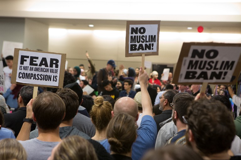 DALLAS, TX - JANUARY 28: Protesters gather to denounce President Donald Trump's executive order that bans certain immigration, at Dallas-Fort Worth International Airport on January 28, 2017 in Dallas, Texas. President Trump signed the controversial executive order that halted refugees and residents from predominantly Muslim countries from entering the United States. G. Morty Ortega/Getty Images/AFP