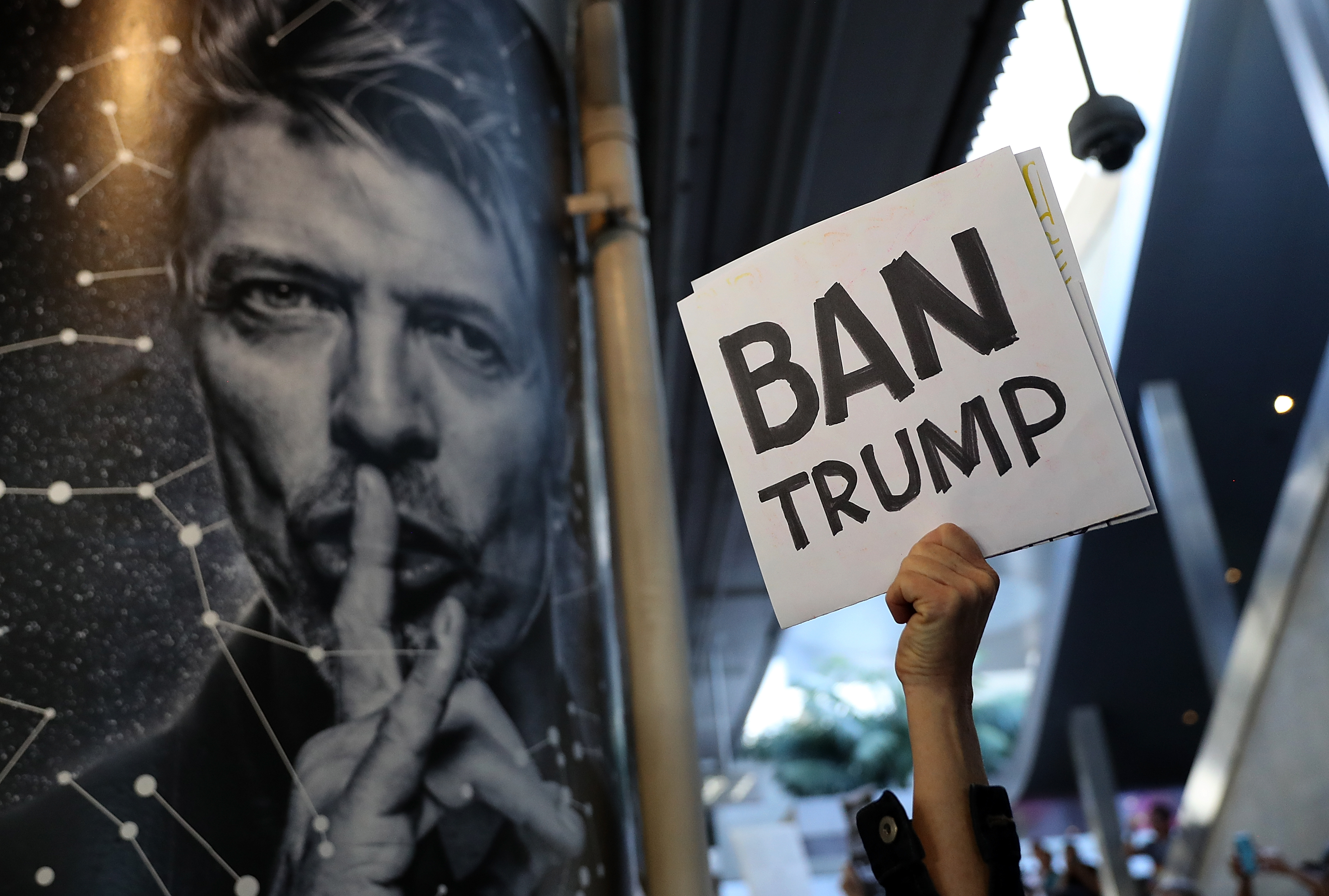 LOS ANGELES, CA - JANUARY 29: A protester holds a sign during a demonstration against the immigration ban that was imposed by U.S. President Donald Trump at Los Angeles International Airport on January 29, 2017 in Los Angeles, California. Thousands of protesters gathered outside of the Tom Bradley International Terminal at Los Angeles International Airport to denounce the travel ban imposed by President Trump. Protests are taking place at airports across the country.   Justin Sullivan/Getty Images/AFP