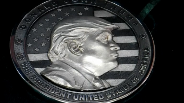 A private company in Russia's Urals mints a series of silver and golden coins featuring Donald Trump to mark his inauguration. (Photo grabbed from Reuters video)