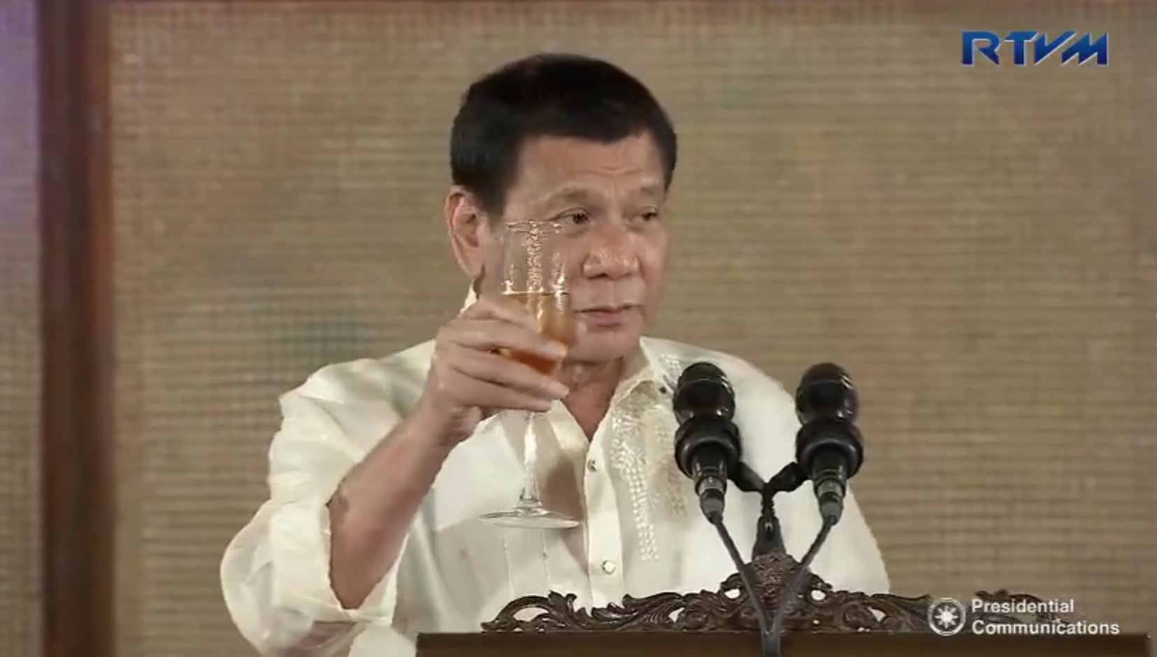 "Kampai! Bottoms up," says President Duterte as he makes a toast after addressing the members of the international community, including the diplomatic corps, during his first hosting of the annual Vin d'Honneur at the Rizal Hall in Malacanang. (Photo grabbed from RTVM video)