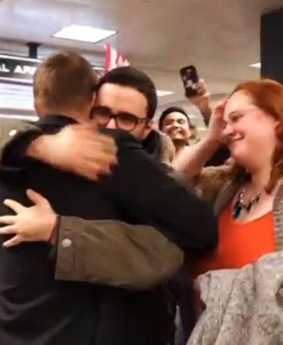 Travellers are greeted by family members in cheerful reunions at Washington Dulles Airport after being temporarily detained following arrival from some of the seven predominantly Muslim countries affected by U.S. President Donald Trump's immigration ban.  (Photo grabbed from Reuters video)