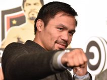 WBO welterweight world champion Manny Pacquiao poses for the media following a press conference at his boxing gym in Tokyo on November 25, 2016. WBO welterweight world champion Manny Pacquiao on November 25 kept alive hopes for a rematch with Floyd Mayweather, saying the epic clash was "possible" but only if his arch rival returns to the ring. / AFP PHOTO / KAZUHIRO NOGI