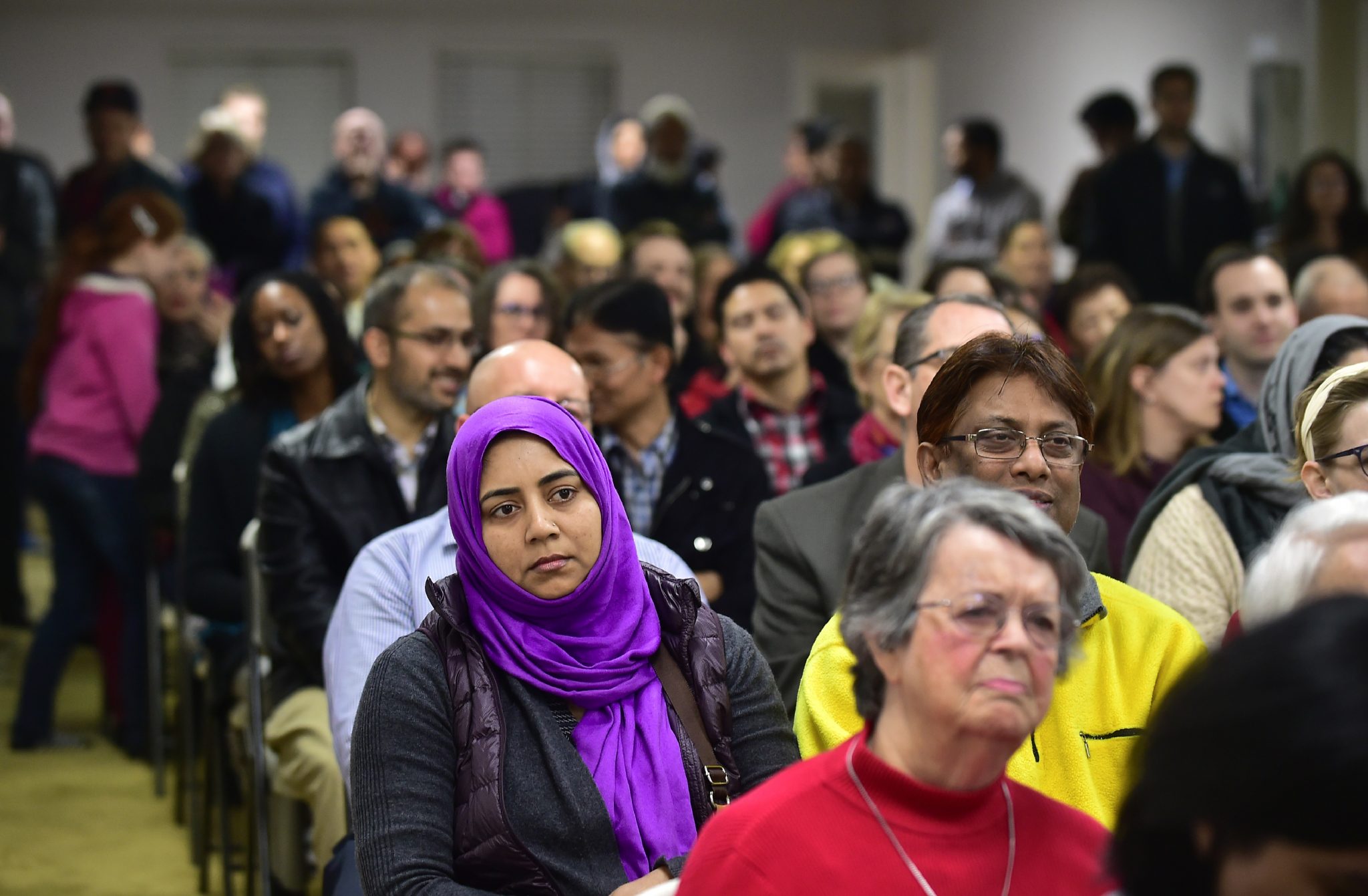 People attend an interfaith solidarity event at Masjid Gibrael Mosque in San Gabriel, California on January 26, 2017, where religious and community leaders denounced hate speech and anti-Muslim proposals that have contributed to a rise in anti-Muslim rhetoric and crime. President Donald Trump is reportedly poised to suspend the US refugee program for four months and halt visas for travellers from seven Muslim countries. A draft executive order published in the Washington Post and New York Times said refugees from war-torn Syria will be indefinitely banned, while the broader US refugee admissions program will be suspended for 120 days as officials draw up a list of low risk countries. / AFP PHOTO / Frederic J. BROWN