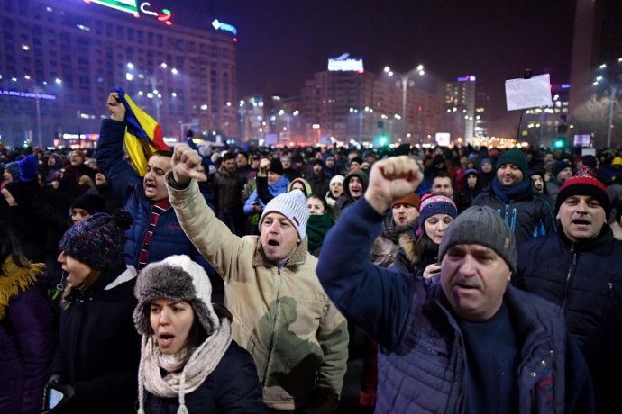 People demonstrate in front of Romanian Government headquarters against controversial decrees to pardon corrupt politicians and decriminalize other offenses, on January 31, 2017 in Bucharest. Thousands of Romanians rally spontaneously in the front of government after a controversial law giving pardon to corruption crimes was adopted by emergency order late evening on January 31, 2017.