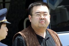 This file photo taken on May 4, 2001 shows an immigration officer escorting Kim Jong-Nam getting off a bus to board an ANA905 (All Nippon Airways) airplane at Narita airport near Tokyo. The half-brother of North Korean leader Kim Jong-Un was assassinated in Malaysia, South Korea's Yonhap news agency said on February 14, 2017. / AFP/ TOSHIFUMI KITAMURA