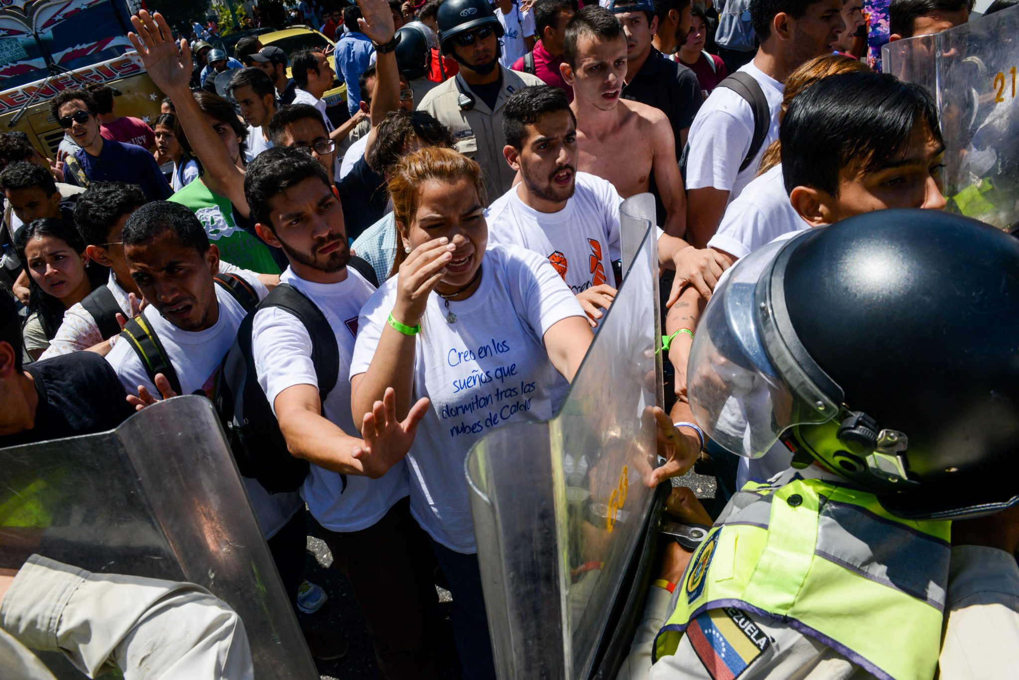University students confront police officers blocking the way of a march demanding early elections to oust Venezuelan President Nicolas Maduro over the country's economic and political crisis, in front of the Central University of Venezuela (UCV) in Caracas on February 15, 2017. The next scheduled general election is in late 2018, with Maduro's current term expiring in early 2019. Recent polls indicate 80 percent of Venezuelans disapprove of him.  / AFP PHOTO / Federico PARRA