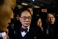 Former Hong Kong chief executive Donald Tsang (C) and his wife Selina (centre R) walk towards their car from the High Court after the jury found him guilty of misconduct in his high-profile corruption trial, in Hong Kong on February 17, 2017. Tsang, 72, is the most senior city official ever to be convicted in a criminal trial, at a time when residents are losing faith in Hong Kong's leaders, as a string of prominent corruption cases fuel public suspicions over cosy links between authorities and business leaders. / AFP PHOTO / ANTHONY WALLACE