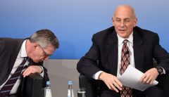 German Interior Minister Thomas de Maiziere (L) looks down beside of US Secretary of Homeland Security John Kelly (R) during a talk on the second day of the 53rd Munich Security Conference (MSC) at the Bayerischer Hof hotel in Munich, southern Germany, on February 18, 2017.  / AFP PHOTO / Christof STACHE