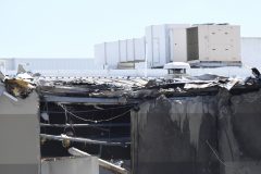 A general view shows damage to the building after a Beechcraft plane crashed into a shopping centre just after tack-off from the Essendon airport in Melbourne on February 21, 2017. A light aircraft carrying five people crashed on February 21 in a "massive fireball", hitting a shopping centre near the Australian city of Melbourne and sending black smoke billowing into the air, witnesses and officials said. / AFP PHOTO / Mal Fairclough