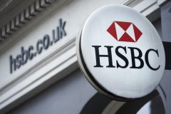 A HSBC bank logo is seen on a sign outside a branch of the bank in central London on February 21, 2017. HSBC profits plunged last year on huge writedowns and restructuring charges, the banking titan said on February 21, warning of uncertainty over Brexit and Donald Trump's economic policies. / AFP PHOTO / NIKLAS HALLE'N