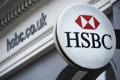 A HSBC bank logo is seen on a sign outside a branch of the bank in central London on February 21, 2017. HSBC profits plunged last year on huge writedowns and restructuring charges, the banking titan said on February 21, warning of uncertainty over Brexit and Donald Trump's economic policies.  / AFP PHOTO / NIKLAS HALLE'N