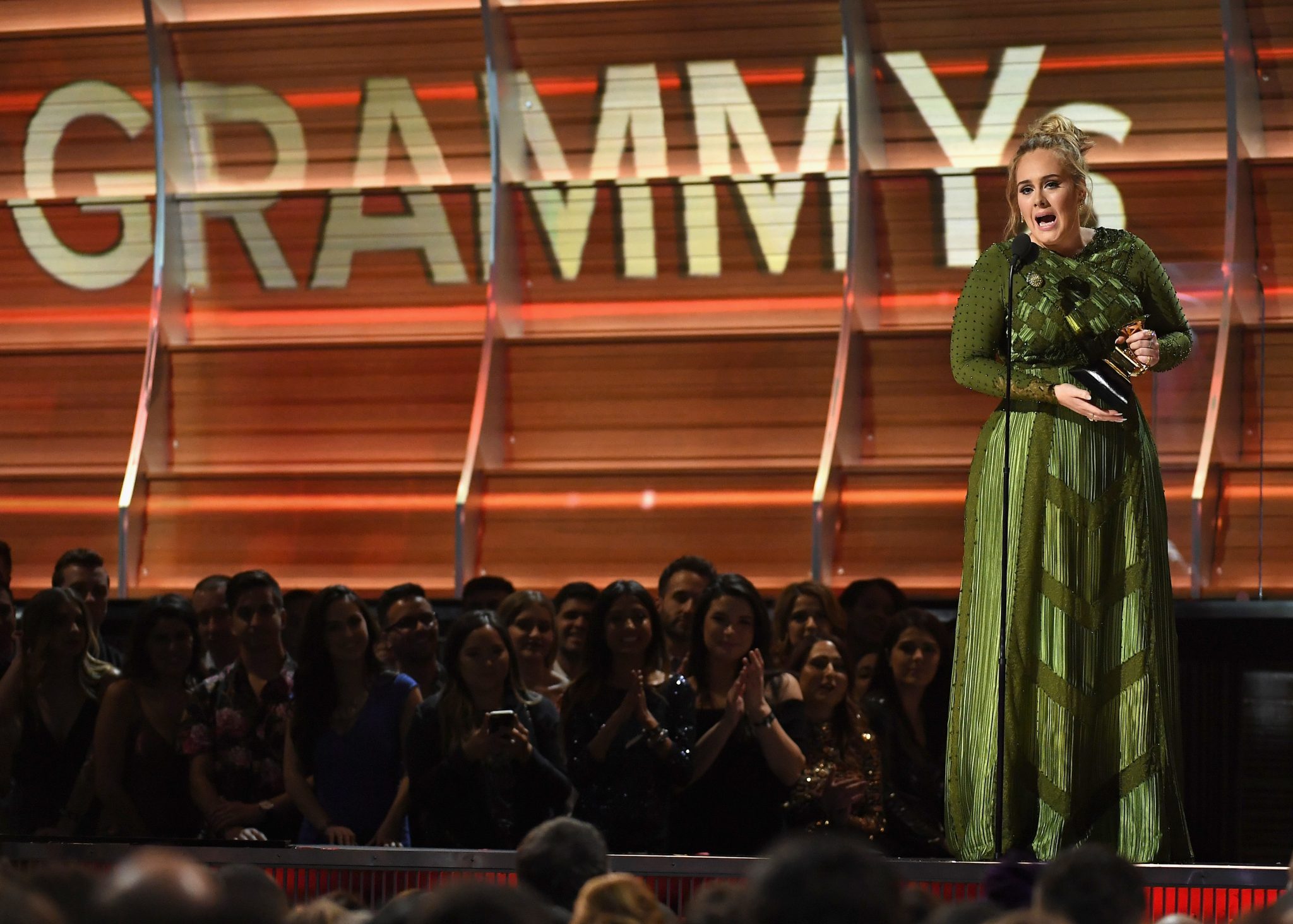 LOS ANGELES, CA - FEBRUARY 12: Recording artist Adele accepts the award for Record of the Year for 'Hello,' onstage during The 59th GRAMMY Awards at STAPLES Center on February 12, 2017 in Los Angeles, California.   Kevork Djansezian/Getty Images/AFP
