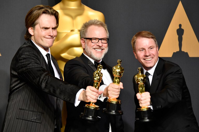 HOLLYWOOD, CA - FEBRUARY 26: (L-R) Co-directors Byron Howard and Rich Moore and producer Clark Spencer, winners of the Best Animated Feature Film award for 'Zootopia' pose in the press room during the 89th Annual Academy Awards at Hollywood & Highland Center on February 26, 2017 in Hollywood, California.   Frazer Harrison/Getty Images/AFP