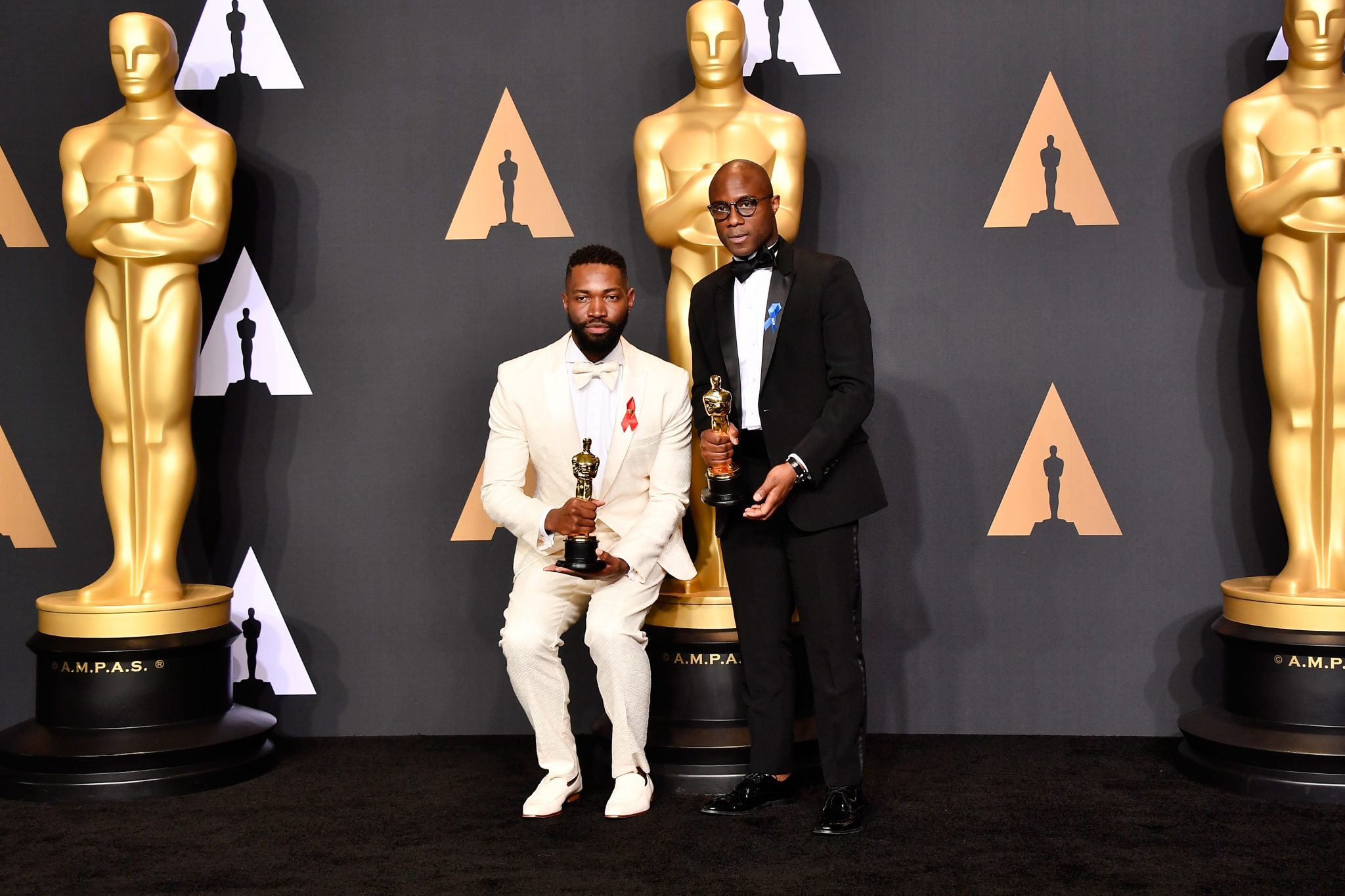HOLLYWOOD, CA - FEBRUARY 26: Screenwriter Tarell Alvin McCraney (L) and writer/director Barry Jenkins, winners of Best Adapted Screenplay for 'Moonlight', pose in the press room during the 89th Annual Academy Awards at Hollywood & Highland Center on February 26, 2017 in Hollywood, California.   Frazer Harrison/Getty Images/AFP