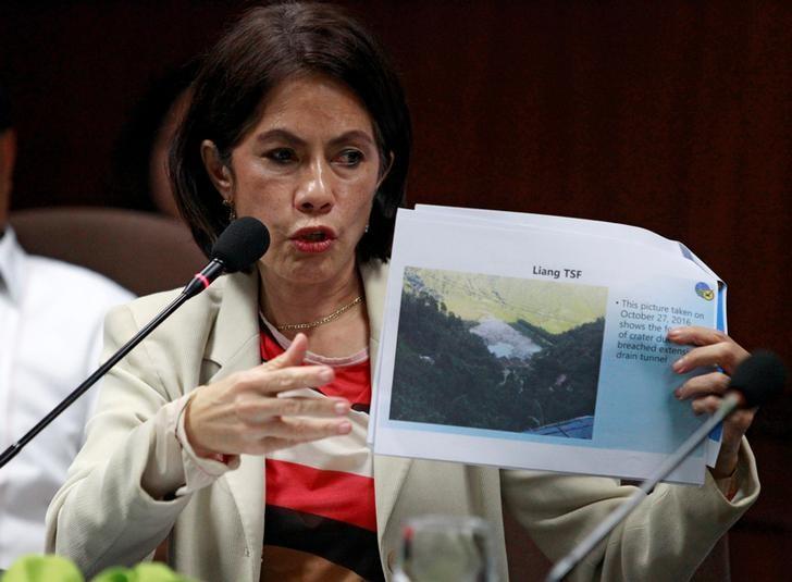 Philippines' Environment and Natural Resources Secretary Regina Lopez shows a picture of Liang tailings storage facility's (TSF) environment compliance certificate (ECC), one of the mining company that has been suspended by the Department of Environment and Natural Resources (DENR) due to vast damage to the environment, during a news conference in Quezon city, Metro Manila, Philippines December 15, 2016. REUTERS/Czar Dancel