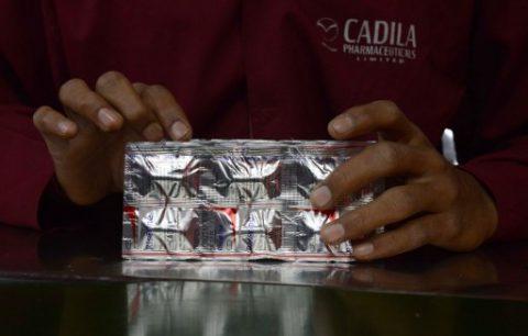 An Indian employee from Cadila Pharmaceuticals Limited packs strips of Risorine capsules at their manufacturing facility on World Tuberculosis (TB) Day in Dholka, some 40 kms from Ahmedabad on March 24, 2015   Risorine, which uses lesser doses of anti-TB drug Rifampicin but with higher efficacy developed indigenously by Indian scientists, could cut short the duration of TB treatment. The World Health Organization has included India on the list of high-burdened countries that contribute to 80 percent of the world's TB problem. AFP PHOTO / Sam PANTHAKY / AFP PHOTO / SAM PANTHAKY
