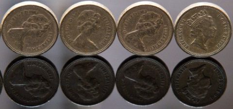 In this posed photograph, £1 (one pound) coins are reflected on a computer tablet screen in London on October 7, 2016. The Bank of England is "looking into" what caused the pound to slump more than six percent against the dollar in less than ten minutes Friday, a spokesman told AFP. / AFP PHOTO / JUSTIN TALLIS