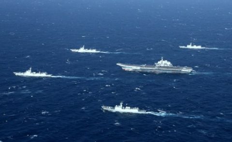 This aerial photo taken on January 2, 2017 shows a Chinese navy formation, including the aircraft carrier Liaoning (C), during military drills in the South China Sea. The aircraft carrier is one of the latest steps in the years-long build-up of China's military, as Beijing seeks greater global power to match its economic might and asserts itself more aggressively in its own backyard.  / AFP PHOTO / STR / China OUT