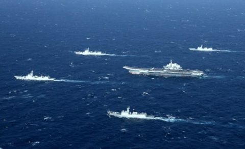 This aerial photo taken on January 2, 2017 shows a Chinese navy formation, including the aircraft carrier Liaoning (C), during military drills in the South China Sea. The aircraft carrier is one of the latest steps in the years-long build-up of China's military, as Beijing seeks greater global power to match its economic might and asserts itself more aggressively in its own backyard. / AFP PHOTO / STR / China OUT