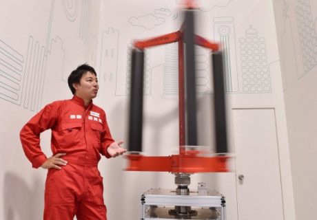 This picture taken on October 20, 2016 shows engineer Atsushi Shimizu, founder and CEO of the Japanese venture company Challenergy, standing next to his bladeless wind turbine in Tokyo. The amount of electricity produced by wind nearly doubled in 2016 from a year earlier, according to a recent survey by the Japan Wind Power Association. But wind power's share of Japan's total energy mix is still less than one percent. / AFP PHOTO / Kazuhiro NOGI / TO GO WITH Japan-energy-environment,FOCUS by Harumi Ozawa