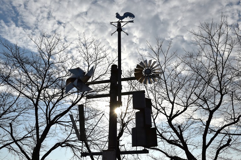 This picture taken on December 20, 2016 shows windmills displayed at the natural energy square in Ashikaga Institute of Technology, Tochigi prefecture. The amount of electricity produced by wind nearly doubled in 2016 from a year earlier, according to a recent survey by the Japan Wind Power Association. But wind power's share of Japan's total energy mix is still less than one percent. / AFP PHOTO / Kazuhiro NOGI / TO GO WITH Japan-energy-environment,FOCUS by Harumi Ozawa