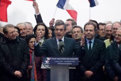 French presidential election candidate for the right-wing Les Republicains (LR) party Francois Fillon (C) gestures as he delivers a speech on stage during a rally at the place du Trocadero, in Paris, on March 5, 2017. Embattled French conservative Francois Fillon told supporters at a Paris rally on March 5, 2017 to "never give up the fight" as he strives to stay in the presidential election race amid an expenses scandal. Fillon, who is to be charged over claims he gave his wife and children highly-paid fake parliamentary jobs, told the rain-drenched crowd he had been "attacked by everyone" in the campaign.  / AFP PHOTO / GEOFFROY VAN DER HASSELT