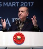 This handout photo taken and released on March 5, 2017 by the Turkish Presidential Press Service shows Turkey's President Recep Tayyip Erdogan addresses a crowd during a Meeting of Women and Democracy Event organized by KADEM (Women and Democracy Association) in Istanbul. Turkish President Recep Tayyip Erdogan lashed out at Germany on March 5 for blocking rallies in support of him ahead of a vote on boosting his powers, likening the ban to "Nazi practices". The attack came a day after German Chancellor Angela Merkel called Turkish Prime Minister Binali Yildirim to try to defuse the row, which has put a major new strain on already bruised ties between the NATO allies. / AFP PHOTO / TURKISH PRESIDENTIAL PRESS SERVICE / MURAT CETIN MUHURDAR