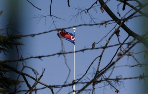 The North Korean national flag flies at the North Korean embassy in Beijing on March 8, 2017. China's foreign minister called for North Korea to suspend its nuclear and missile activities, and for the US and South Korea to halt military exercises to cool what he called a looming security "crisis." / AFP PHOTO / FRED DUFOUR