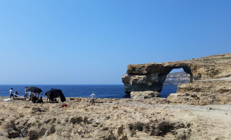A picture taken on July 21, 2017 in Malta shows the Azure Window, a limestone arch on Gozo island. Gale force winds and high waves have destroyed the iconic Azure Window on the island of Gozo, Maltas sister island. The Azure Window has represented Gozo and the islands enduring raw beauty for many years and is believed to have formed about in the mid 19th century. The massive arch landmark with its flat top over the sea at Dwejra, endured raging seas but the storms that hit Malta and Gozo in the last couple of days swept the entire structure away at 9.40am on Wednesday. No one was injured. / AFP PHOTO / Amélie BOTTOLLIER-DEPOIS