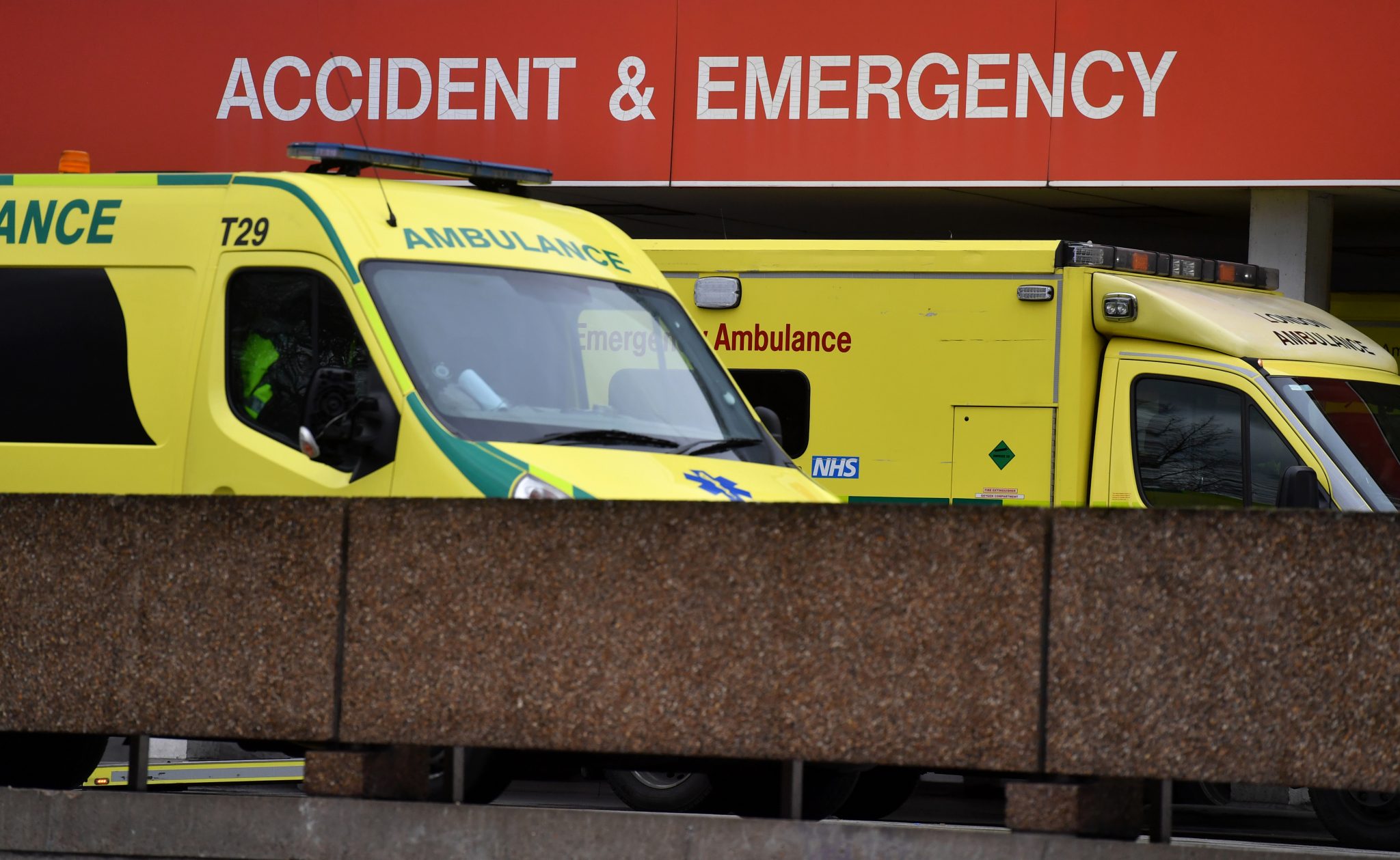 Ambulances are pictured outside the Accident & Emergency (A&E) department of St Thomas' Hospital in central London on March 8, 2017. Britain's economy will grow by 2.0 percent this year, sharply up on a previous forecast of 1.4 percent, finance minister Philip Hammond said Wednesday in his budget statement. Hammond also announced a two billion pound increase in spending for social care, over the next three years, in an effort to tackle pressure on the NHS. / AFP PHOTO / BEN STANSALL