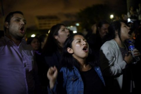 People shout slogans demanding the resignation of Guatemalan President Jimmy Morales during a demonstration outside the Culture Palace in Guatemala City on March 9, 2017, following the death of 34 girls in a recent fire at a government-run children's shelter in San Jose Pinula, east of the capital. Guatemala recoiled in anger and shock Thursday at the deaths of 34 teenage girls in a fire at a government-run shelter where staff have been accused of sexual abuse and other mistreatment. Around 20 more survivors remained hospitalized, most of them in critical condition, according to hospital officials. / AFP PHOTO / JOHAN ORDONEZ