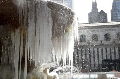 The Josephine Shaw Lowell Memorial Fountain in Bryant Park is covered in ice on March 13, 2017 as the weather continues to be below freezing. The northeastern United States braced Monday for what meteorologists predict could be the worst winter storm of the season, with blizzards feared to dump knee-high snow on New York. / AFP PHOTO / TIMOTHY A. CLARY