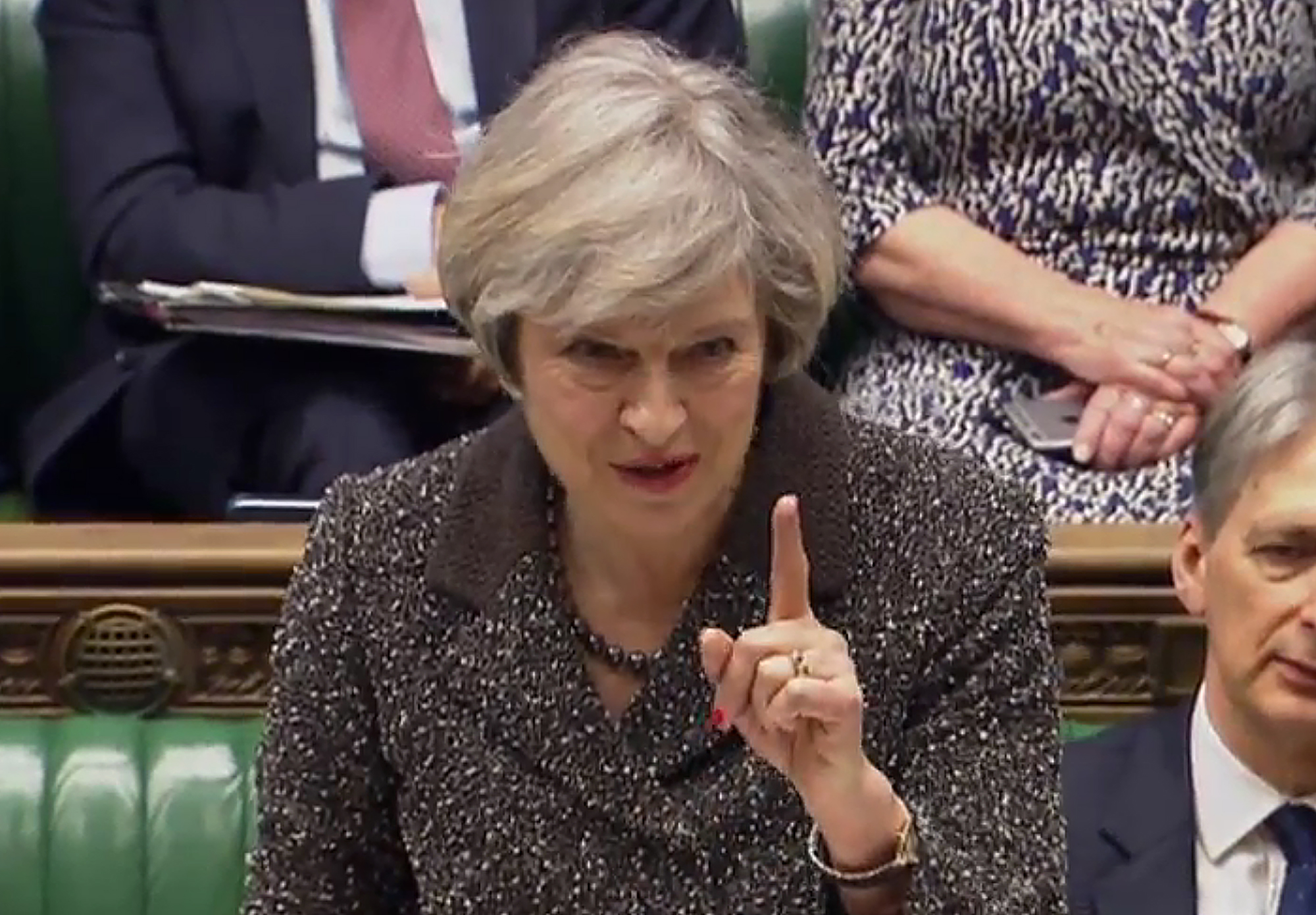 A video grab from footage broadcast by the UK Parliament's Parliamentary Recording Unit (PRU) shows British Prime Minister Theresa May as she reacts to heckling during her speech in the House of Commons in London on March 14, 2017. British Prime Minister Theresa May will make a major statement to parliament on Tuesday, just hours after MPs enabled her to start the withdrawal process from the European Union. / AFP PHOTO / PRU AND AFP PHOTO / HO / RESTRICTED TO EDITORIAL USE - MANDATORY CREDIT " AFP PHOTO / PRU " - NO MARKETING NO ADVERTISING CAMPAIGNS - NO RESALE - NO DISTRIBUTION TO THIRD PARTIES - 24 HOURS USE - NO ARCHIVES