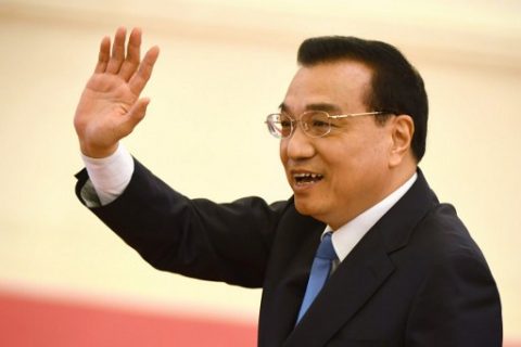 China's Premier Li Keqiang waves to journalists at the end of a press conference after the closing session of the National People's Congress (NPC) in the Great Hall of the People in Beijing on March 15, 2017. / AFP PHOTO / Greg Baker