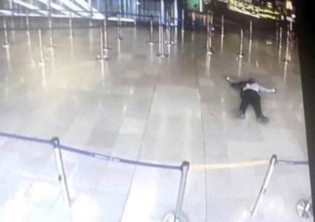 A picture taken from the screen of a monitor on March 18, 2017 shows a man lying on the ground of a terminal building at Paris' Orly airport after he was shot by French security forces for taking a weapon from a soldier. Security forces at Paris' Orly airport shot dead a man who took a weapon from a soldier, the interior ministry said. Witnesses said the airport was evacuated following the shooting at around 8:30am (0730GMT). The man fled into a shop at the airport before he was shot dead, an interior ministry spokesman told AFP. He said there were no people were wounded in the incident. / AFP PHOTO / - / ALTERNATIVE CROP