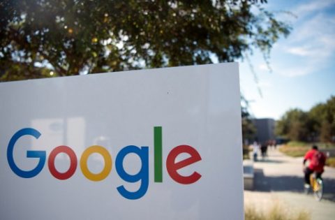 (FILES) This file photo taken on November 4, 2016 shows a man rideing a bike past a Google sign and logo at the Googleplex in Menlo Park, California. Google painted a bleak picture of cybersecurity trends March 20, 2017, saying the number of websites hacked rose 32 percent last year, with little relief in sight."We don't expect this trend to slow down. As hackers get more aggressive and more sites become outdated, hackers will continue to capitalize by infecting more sites," Google said in a post on its webmaster blog. / AFP PHOTO / JOSH EDELSON