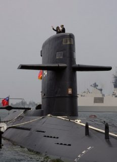 Taiwan President Tsai Ing-wen waves from a Duch-made Sea Tiger submarine at the Tsoying navy base in Kaohsiung, southern Taiwan on March 21, 2017. Taiwan formally launched an ambitious project to build its own submarines as the island faces growing military threats from China as relations deteriorate. / AFP PHOTO / SAM YEH
