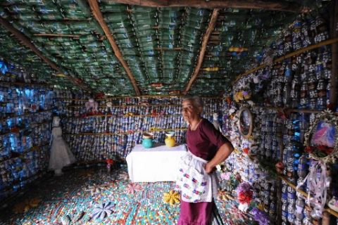 Maria Ponce, 76, stands inside her house made out of plastic bottles, in the village of El Borbollon, San Miguel Province, El Salvador, 125 kilometres from San Salvador on April 2, 2007. Maria built up the house four years ago with plastic bottles because she did not have enough money to make it in the usual way. AFP PHOTO/Jose CABEZAS / AFP PHOTO / Jose CABEZAS