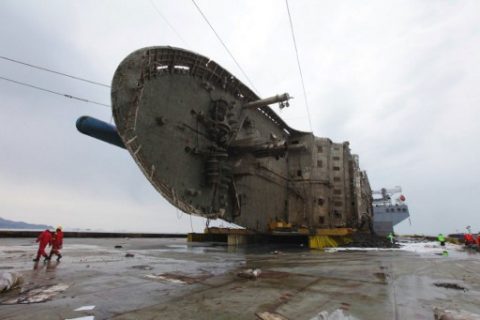 This handout photo provided and taken on March 26, 2017 by the South Korean Maritime Ministry shows the wreck of the Sewol ferry placed onto a submersible vessel off the coast of the southern South Korean island of Jindo. South Korea's sunken Sewol ferry has been successfully hauled onto a giant heavy lifting ship, officials said on March 25, a step towards returning the vessel to port. / AFP PHOTO / SOUTH KOREAN MARITIME MINISTRY / HANDOUT / RESTRICTED TO EDITORIAL USE - MANDATORY CREDIT "AFP PHOTO / South Korean Maritime Ministry" - NO MARKETING NO ADVERTISING CAMPAIGNS - DISTRIBUTED AS A SERVICE TO CLIENTS