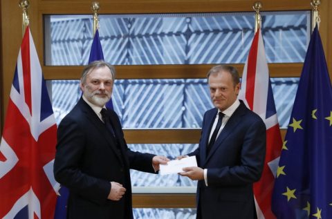 Britain's ambassador to the EU Tim Barrow (L) delivers British Prime Minister Theresa May's formal notice of the UK's intention to leave the bloc under Article 50 of the EU's Lisbon Treaty to European Council President Donald Tusk in Brussels on March 29, 2017. Britain formally launches the process for leaving the European Union on Wednesday, a historic step that has divided the country and thrown into question the future of the European unity project. / AFP PHOTO / POOL / YVES HERMAN