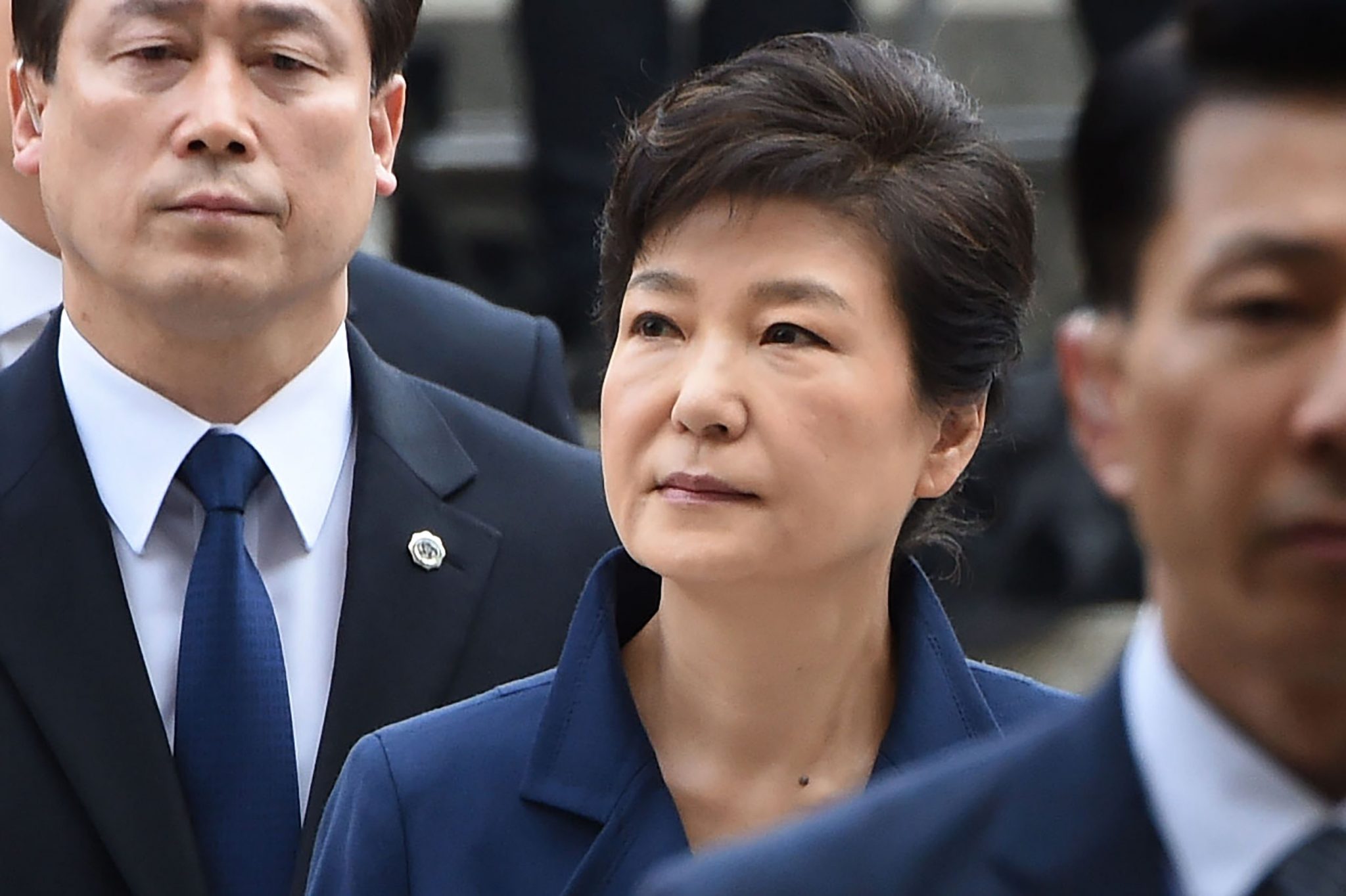 South Korea's ousted president Park Geun-Hye (C) arrives for a hearing to decide whether she should be arrested over the corruption and abuse of power scandal that brought her down, at a court in Seoul on March 30, 2017. Her formal detention and transfer to custody would be a key step in the disgrace of South Korea's first woman president, who secured the largest vote share of any candidate in the democratic era when she was elected in 2012. Park had her removal from office confirmed by the country's top court earlier this month, ending her executive immunity, and her prosecution has been a key demand of the millions of people who took to the streets to protest against her. / AFP PHOTO / YONHAP / YONHAP / REPUBLIC OF KOREA OUT NO ARCHIVES RESTRICTED TO SUBSCRIPTION USE