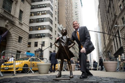 NEW YORK, NY - MARCH 27: New York City Mayor Bill De Blasio poses for a photo with the 'Fearless Girl' statue during a press availability, March 27, 2017 in New York City. De Blasio announced that the popular statue of a young girl staring down the famous Wall Street 'Charing Bull' will stay in place until February 2018. Drew Angerer/Getty Images/AFP
